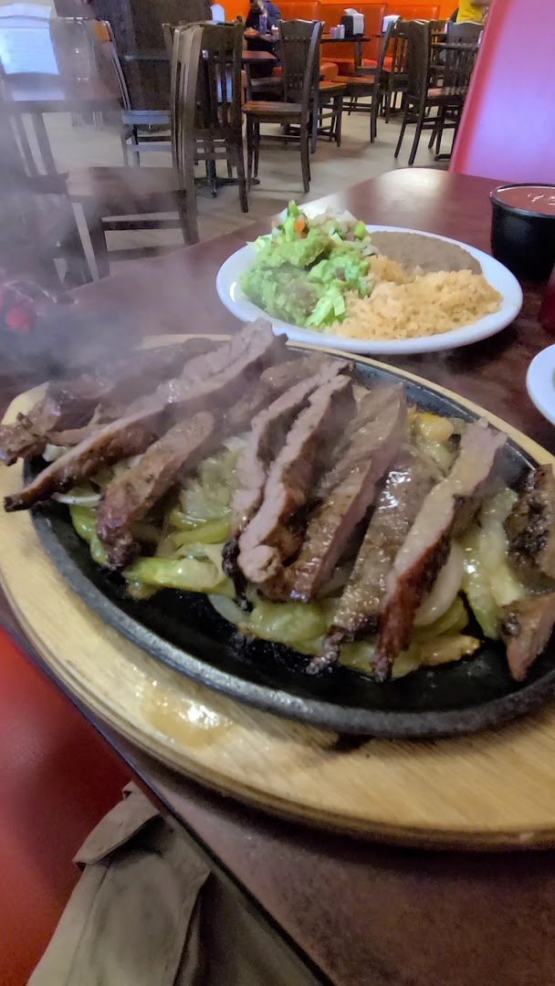 Tacos and enchiladas served with fresh sides.