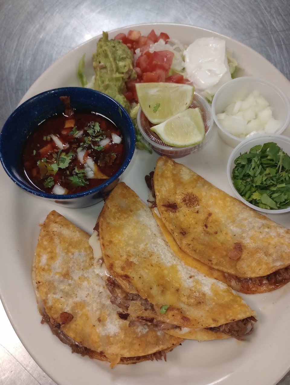 Printed menu with tacos, enchiladas, and fajitas.